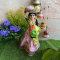 Navarathri handcrafted Flower Seller doll in pink and gold attire carrying a basket of colorful flowers, ideal for Golu decoration.