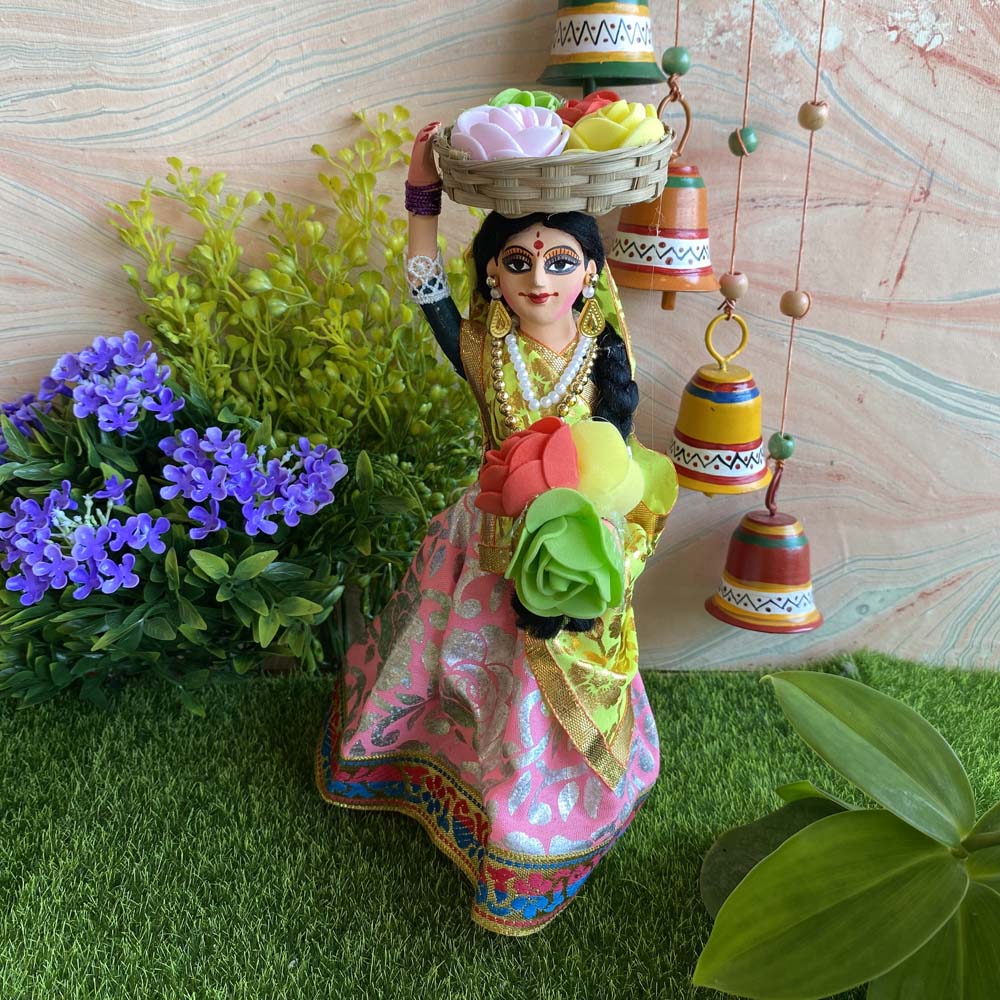 Navarathri handcrafted Flower Seller doll in pink and gold attire carrying a basket of colorful flowers, ideal for Golu decoration.