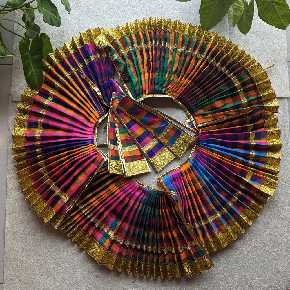A vibrant collection of traditional checked Kalasa skirts with golden borders arranged in a circular pattern, ideal for ceremonial and festive decor.