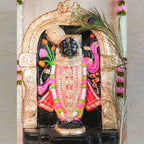 Handcrafted Navarathri Golu doll of Lord Krishna in Dwaraka, adorned with vibrant pink, gold, and black detailing under a decorative arch.
