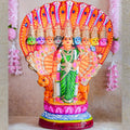 Handcrafted Navarathri Golu Doll of Nava Durga under a serpent canopy, adorned in vibrant colors with a lion mount.