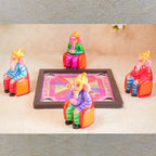 Handcrafted Navarathri Golu doll set of four Ganeshas seated around a carrom board, engaging in a game.