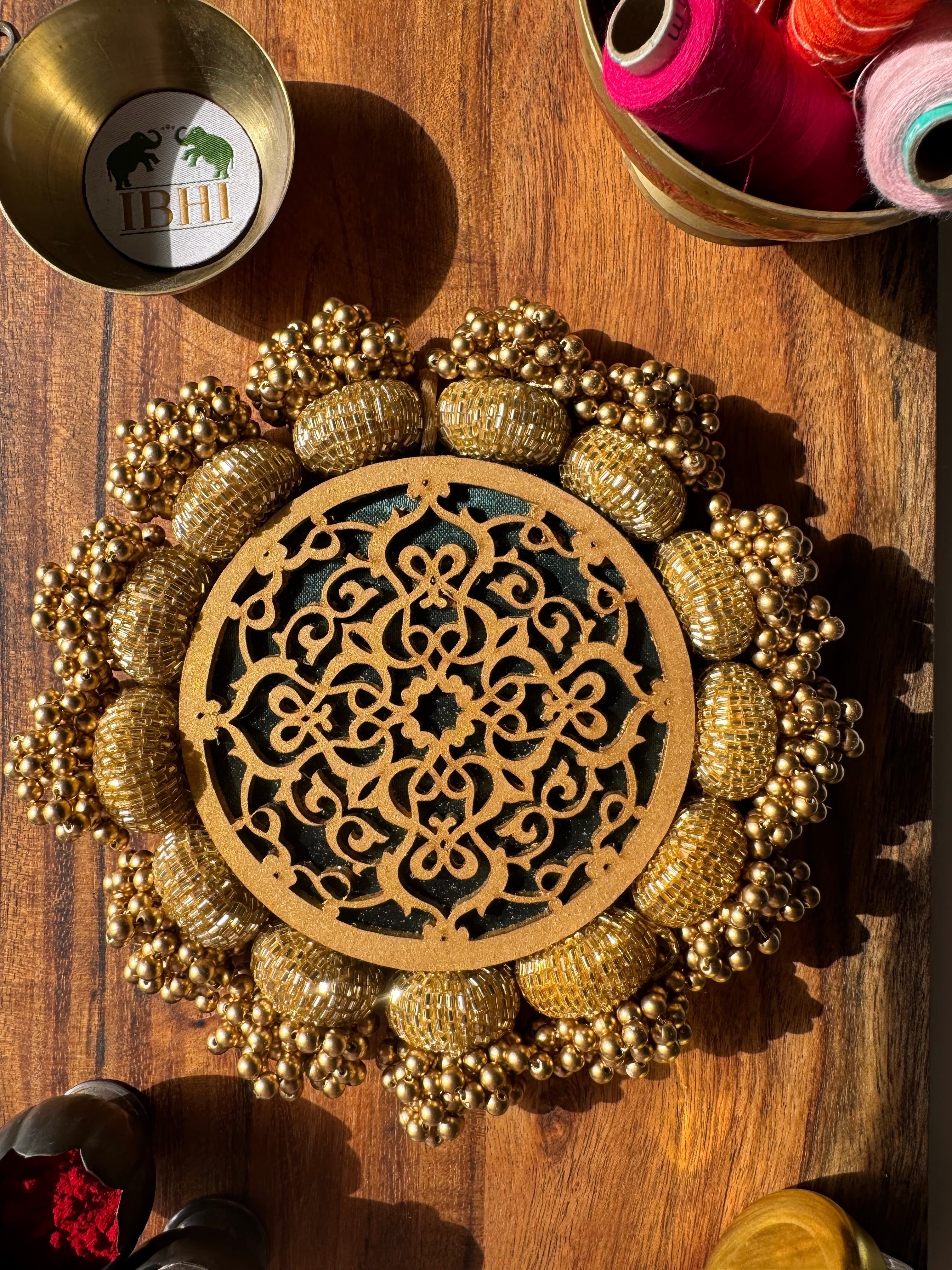 Handmade green and gold round Platter with jaal design and Patola print

