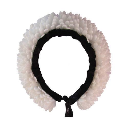 Handcrafted white Konda flower garland with green accents placed on a woven basket, perfect for hair decoration