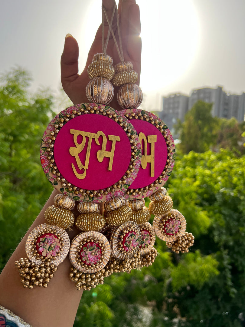 Shubh Labh hanging pair, pink, held in hand