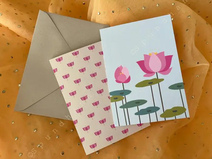 Two different lotus-themed greeting cards with a cream colored kraft envelope on bright yellow background.