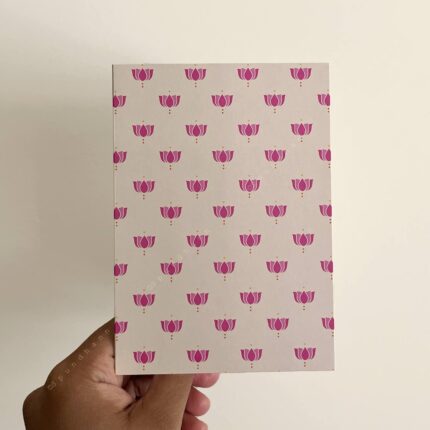 Off white greeting card with pink lotus block print all over.