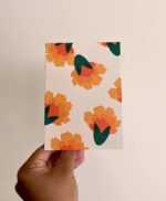 Light off-white greeting card with marigolds all over.